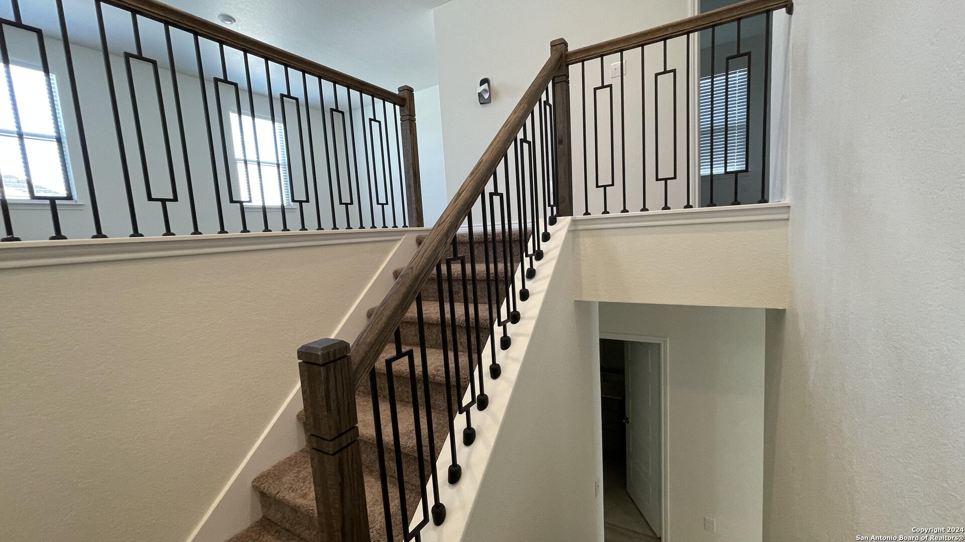 14839 Vance Jackson Road, Unit 606 San Antonio, TX 78249 - Photo 6 of 13 a view of staircase with wooden floor and a window