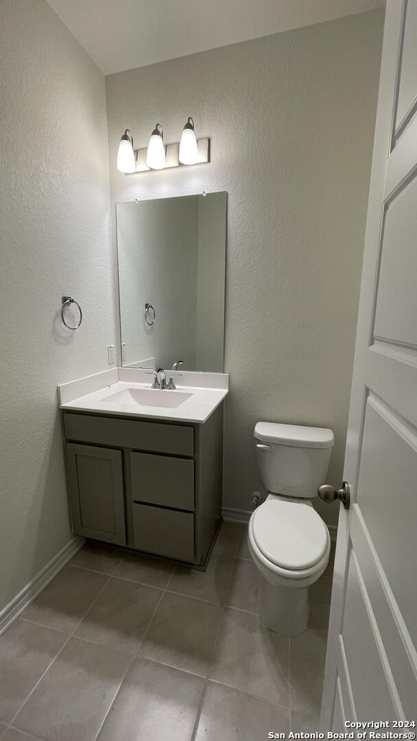 14839 Vance Jackson Road, Unit 606 San Antonio, TX 78249 - Photo 8 of 13 a bathroom with a toilet sink and mirror