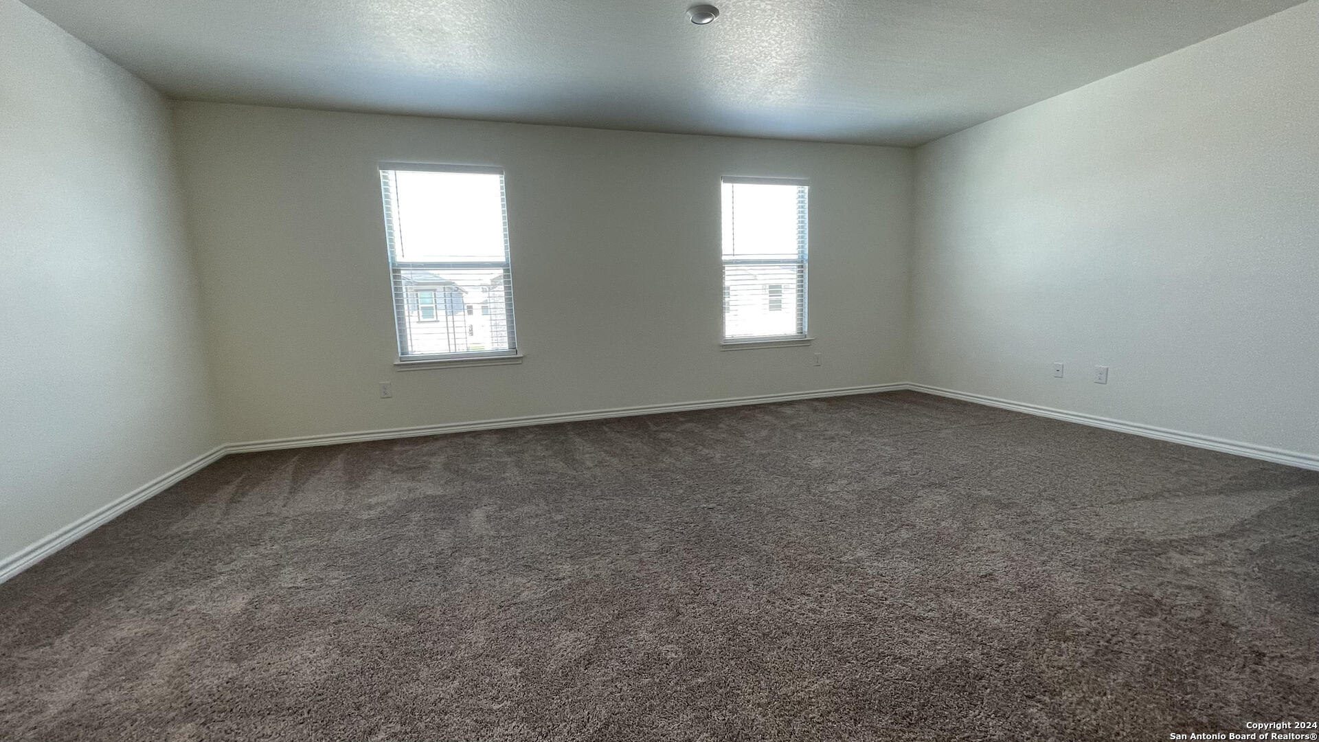 14839 Vance Jackson Road, Unit 606 San Antonio, TX 78249 - Photo 9 of 13 an empty room with windows