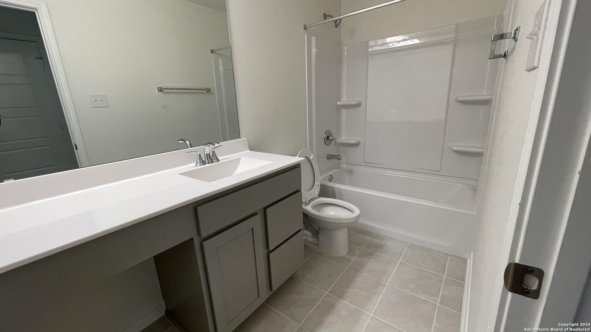 14839 Vance Jackson Road, Unit 606 San Antonio, TX 78249 - Photo 10 of 13 a bathroom with a sink a toilet and shower
