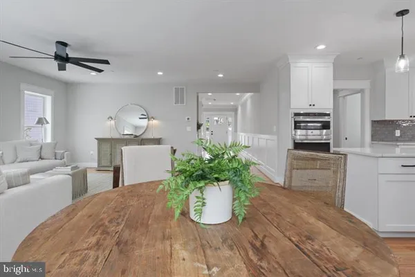 a room with kitchen island stainless steel appliances sink cabinets and stove