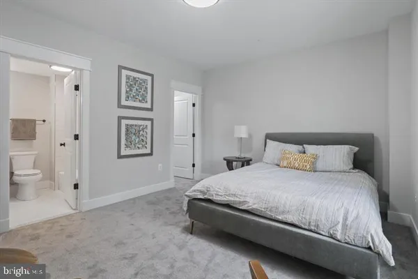 a bedroom with a bed and a view of bathroom