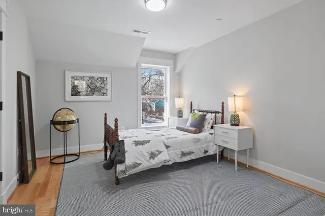 a bedroom with bed and a window