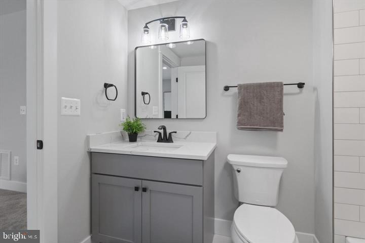 2806 Norbeck Road Silver Spring, MD 20906 - Photo 22 of 36 a bathroom with a toilet a sink and mirror