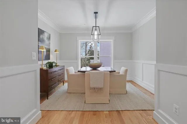 a living room with furniture a window and a dining table