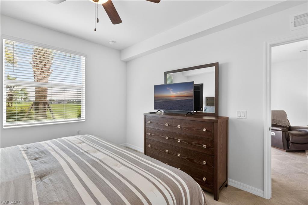 43985 Boardwalk Loop, Unit 2115 Punta Gorda, FL 33982 - Photo 12 of 28 a bedroom with a bed and a television