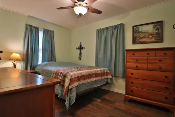 a bedroom with a bed and a chandelier
