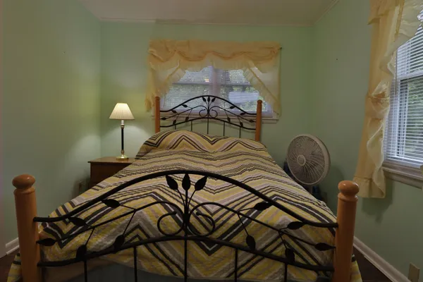 a bedroom with a bed and a chandelier