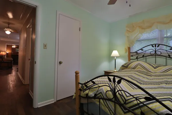 a bedroom with a bed and a mirror