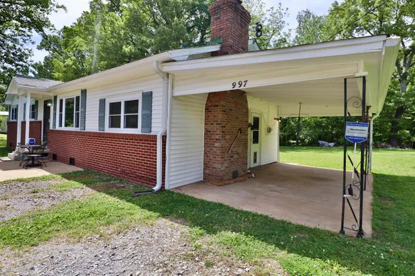 a front view of house with yard and green space