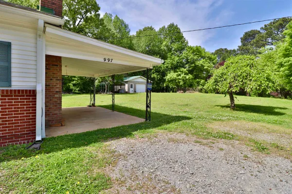 a view of a house with a backyard