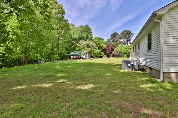a house with lots of trees in the background