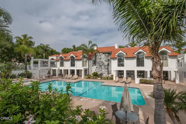 an outdoor view of a house with a backyard