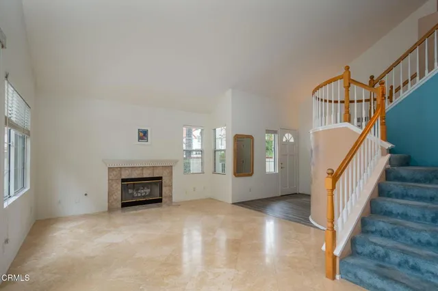 a view of an empty room with a fireplace