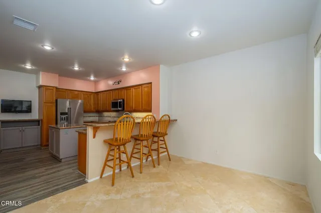 a view of kitchen with refrigerator microwave and stove