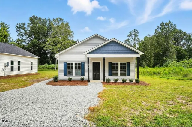 a front view of a house with a yard table and chairs