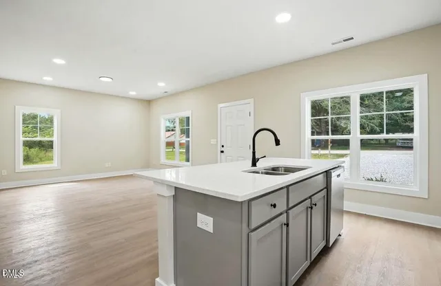 a kitchen with a sink and large window