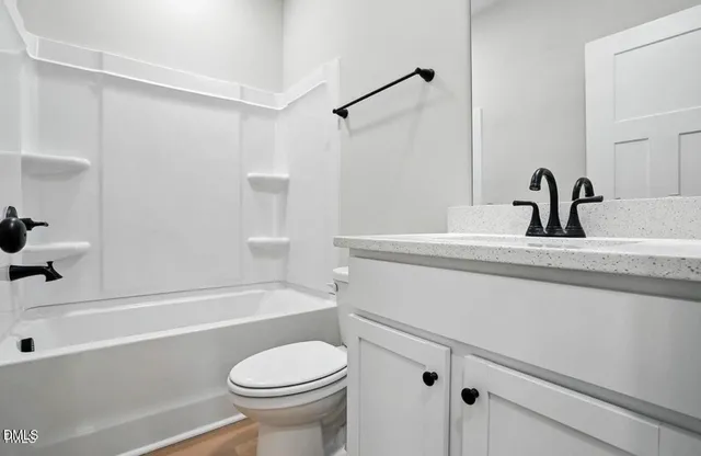 a bathroom with a sink a toilet and a bathtub