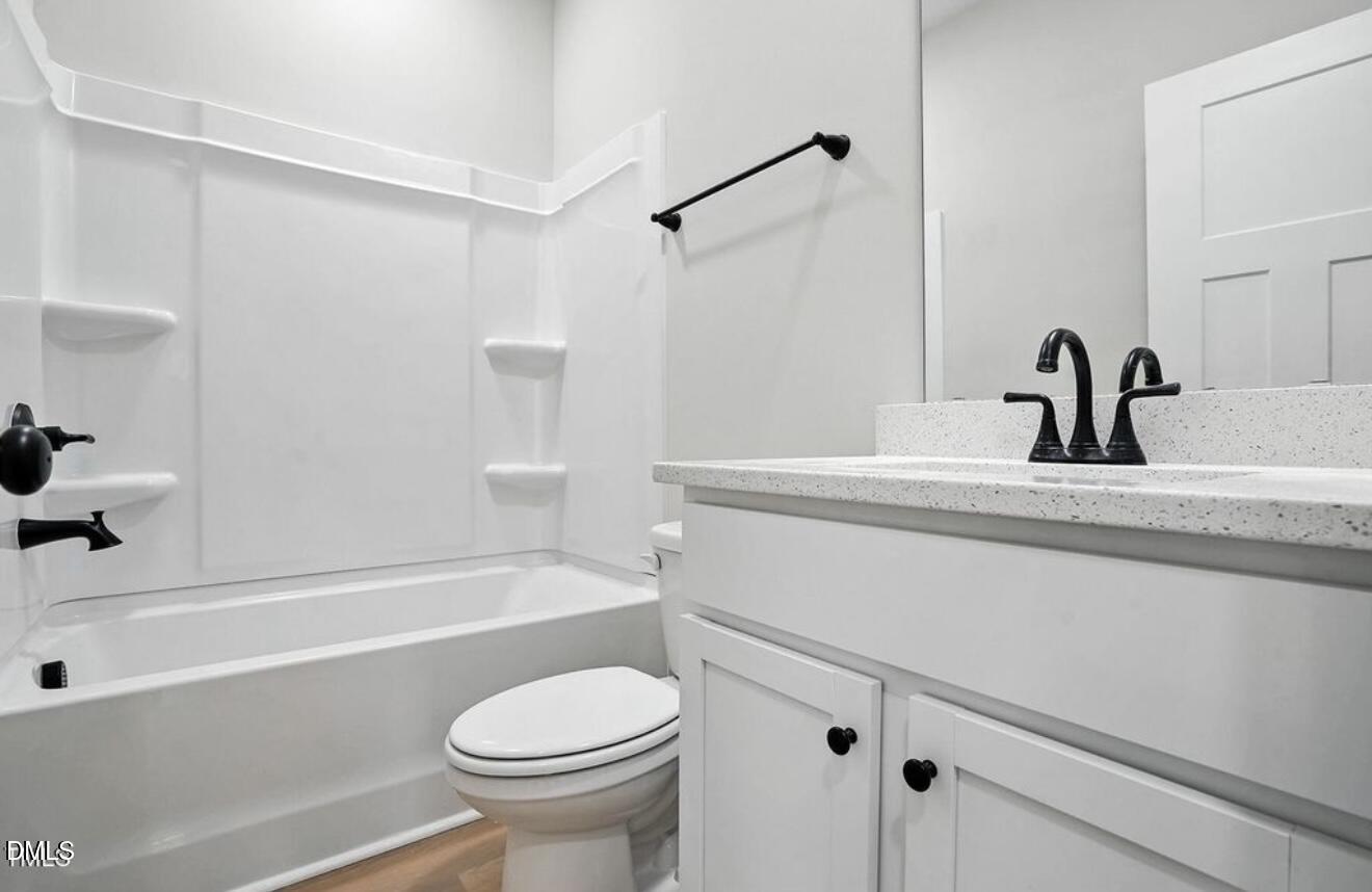 1240 West Blackman Road Dunn, NC 28334 - Photo 15 of 25 a bathroom with a sink a toilet and a bathtub