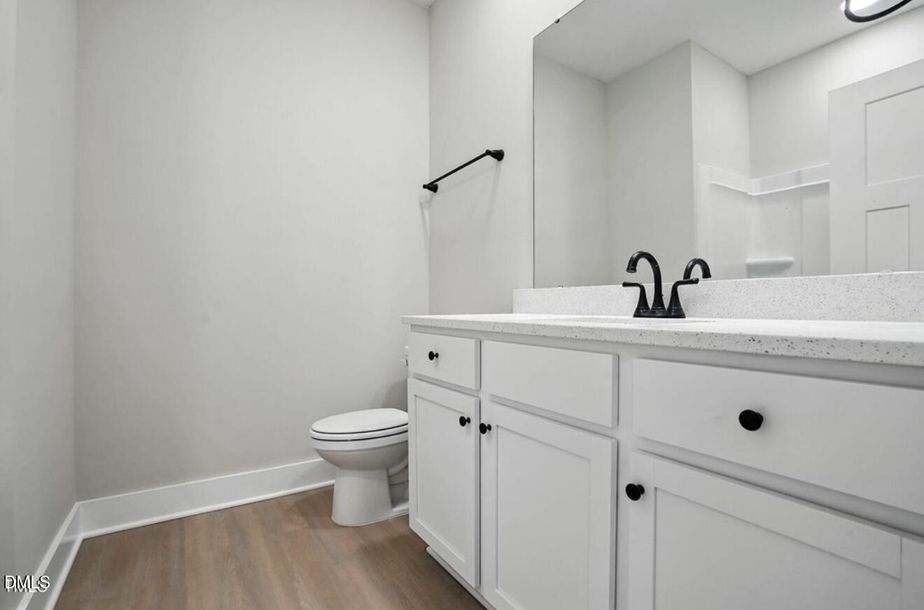 1240 West Blackman Road Dunn, NC 28334 - Photo 20 of 25 a bathroom with a sink a toilet and mirror