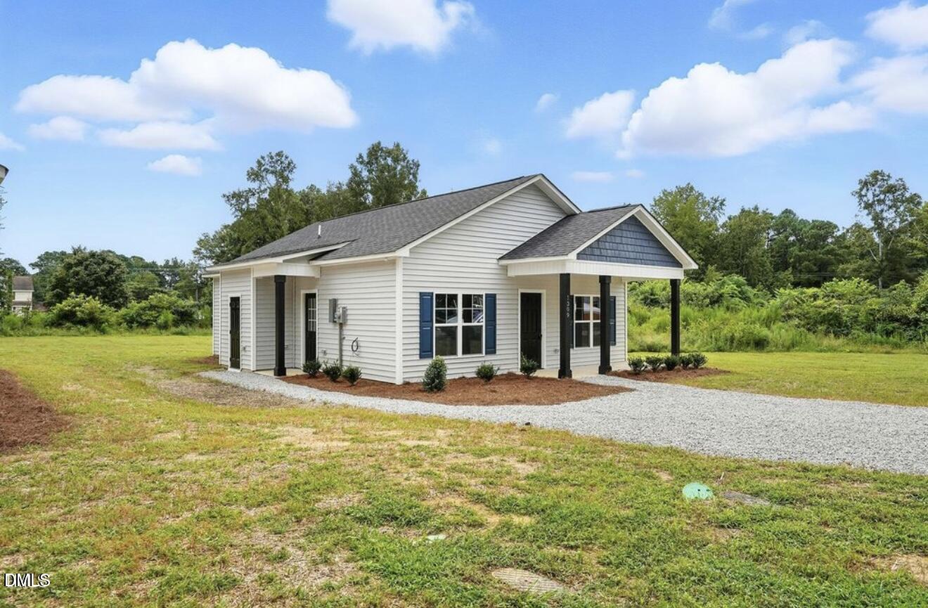 1240 West Blackman Road Dunn, NC 28334 - Photo 2 of 25 a front view of a house with a yard and porch