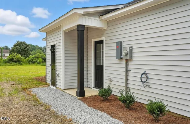 a view of a house with a yard and stairs