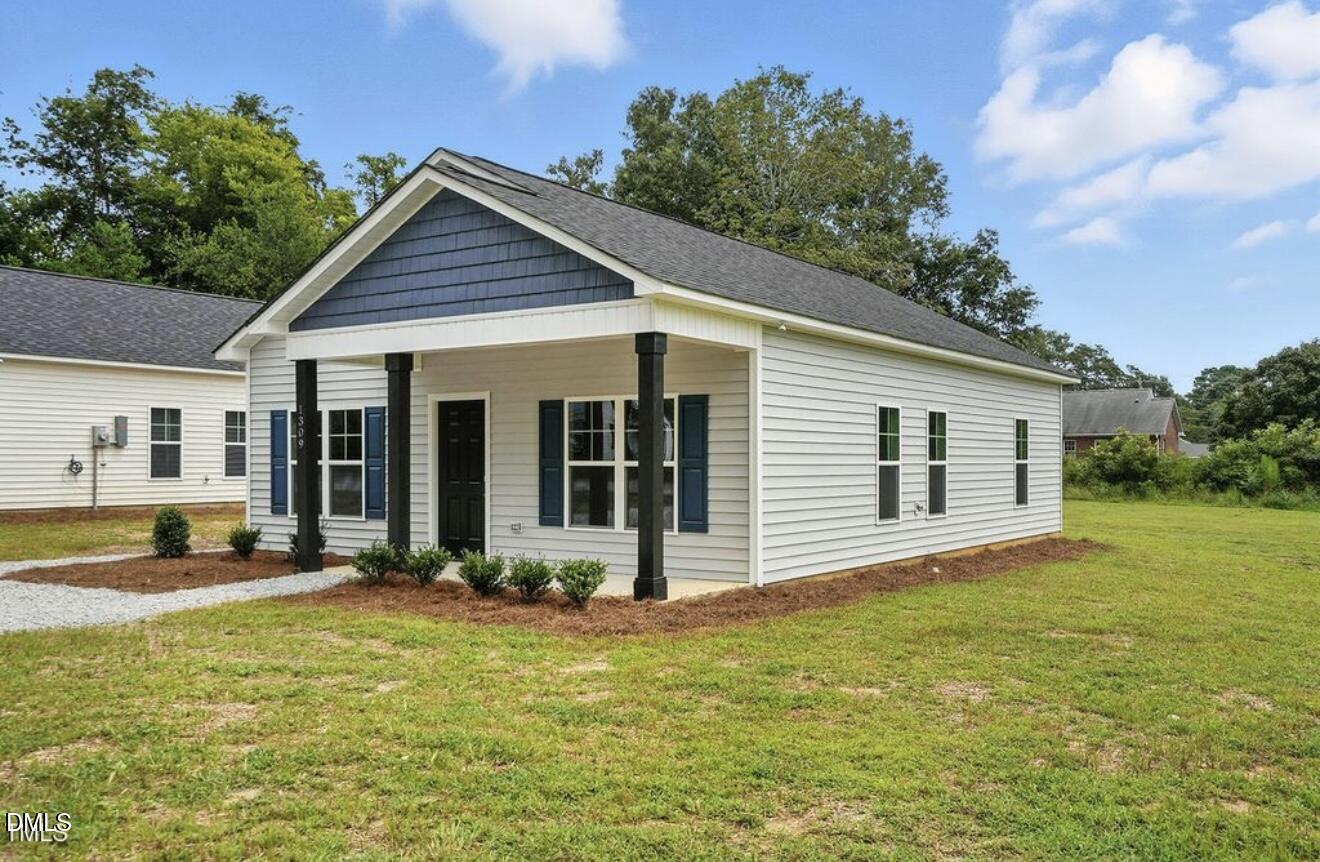 1240 West Blackman Road Dunn, NC 28334 - Photo 3 of 25 a view of a house with a yard