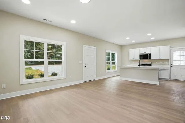 a view of kitchen with cabinets and wooden floor