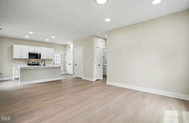 a view of kitchen with microwave and cabinets