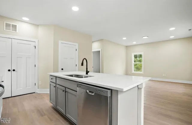 a kitchen with a sink and a mirror