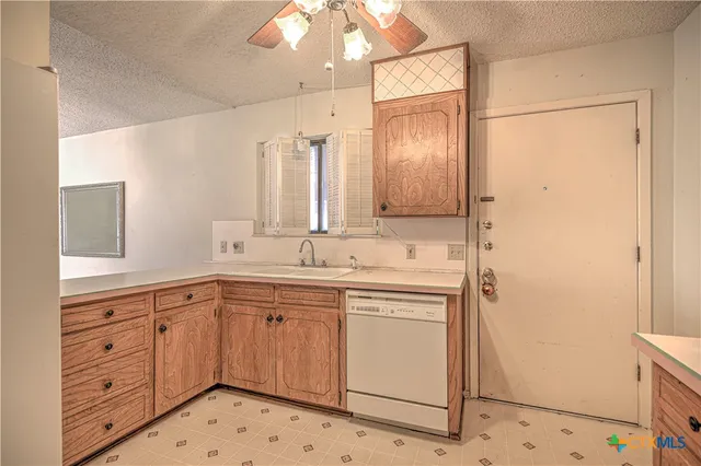 a view of a sink and a refrigerator in a bathroom