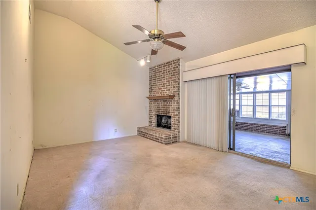 a view of an empty room with a fireplace