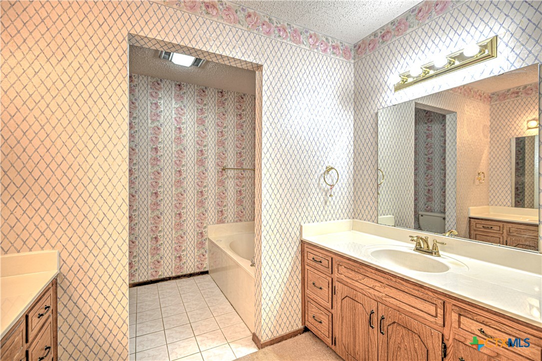 4000 Hickory Road, Unit 3 Temple, TX 76502 - Photo 23 of 34 a bathroom with a sink a mirror and a bathtub
