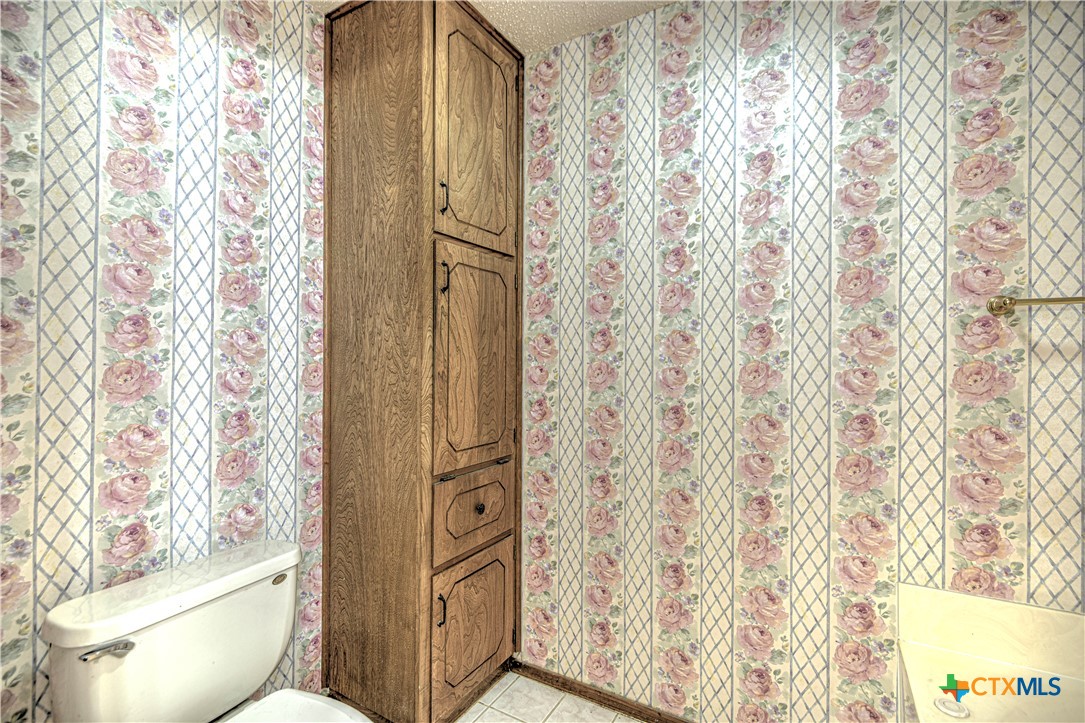 4000 Hickory Road, Unit 3 Temple, TX 76502 - Photo 24 of 34 a bathroom with a toilet and shower curtain