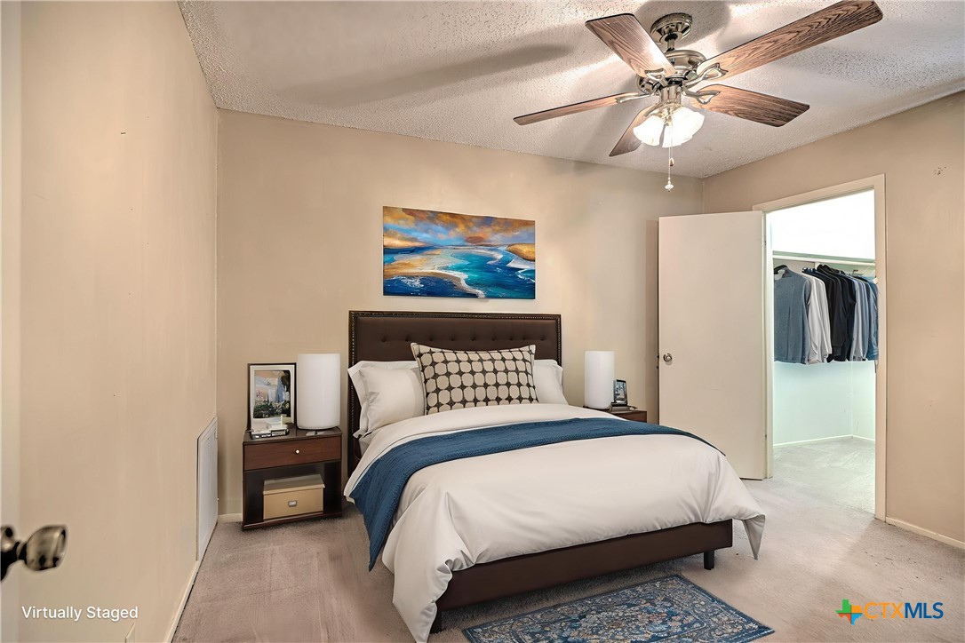4000 Hickory Road, Unit 3 Temple, TX 76502 - Photo 26 of 34 a bedroom with a bed and a chandelier