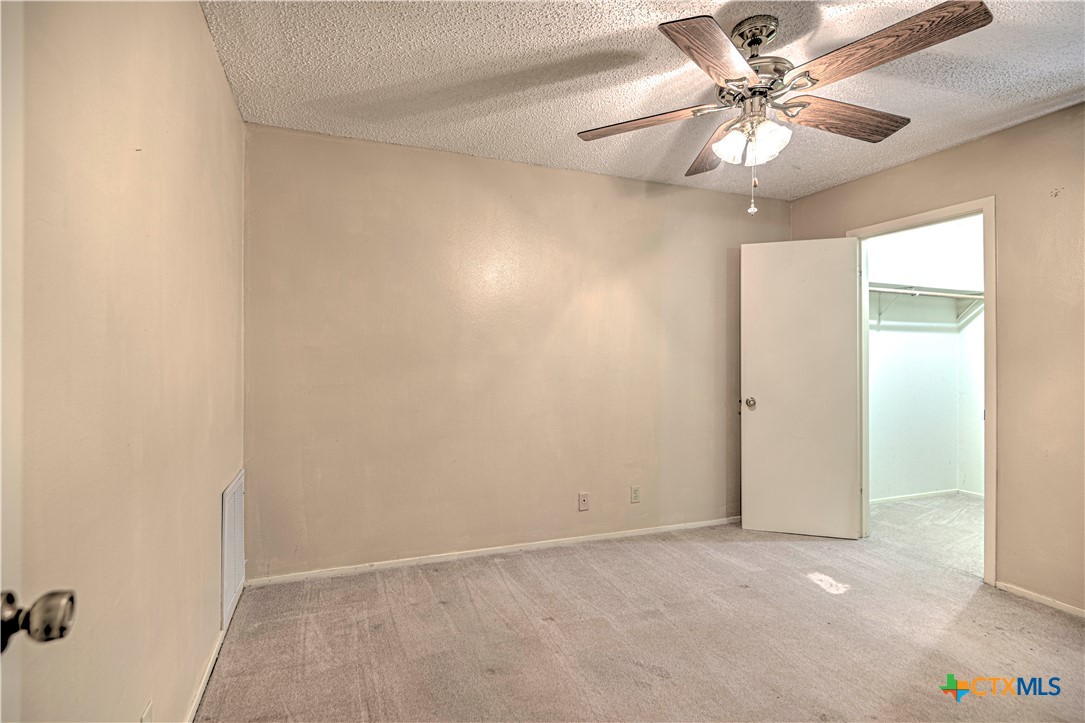 4000 Hickory Road, Unit 3 Temple, TX 76502 - Photo 27 of 34 an empty room with a ceiling fan and a window