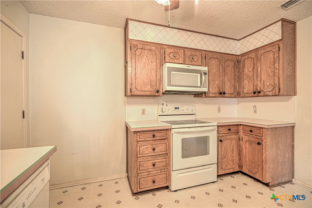 4000 Hickory Road, Unit 3 Temple, TX 76502 - Photo 10 of 34 a kitchen with stainless steel appliances a stove a sink and a microwave