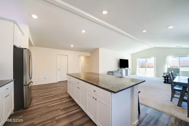 a kitchen with sink refrigerator and dining table