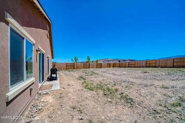 a backyard of a house with shaded area