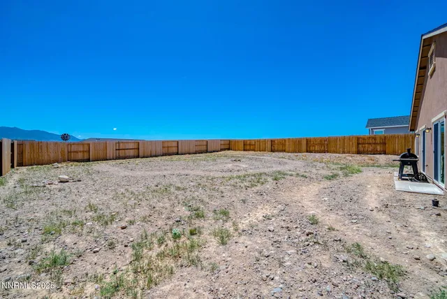 a view of a large house with a yard and large tree