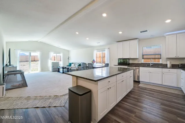 a kitchen with granite countertop counter space a sink appliances and cabinets