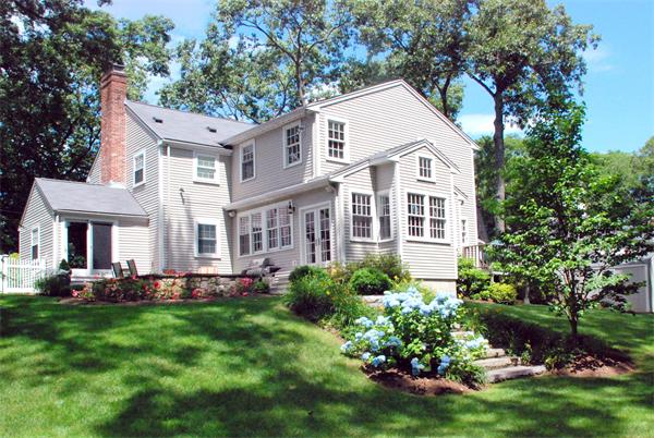 43 River Glen Road Wellesley, MA 02481 - Photo 2 of 20 a front view of a house with a garden and plants