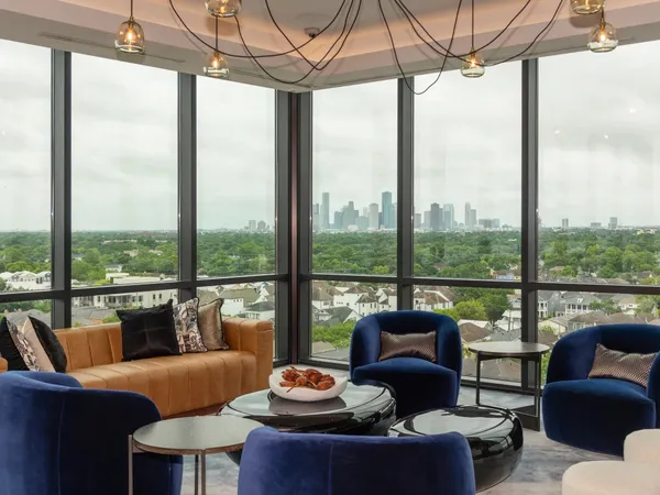 a living room with furniture and a floor to ceiling window