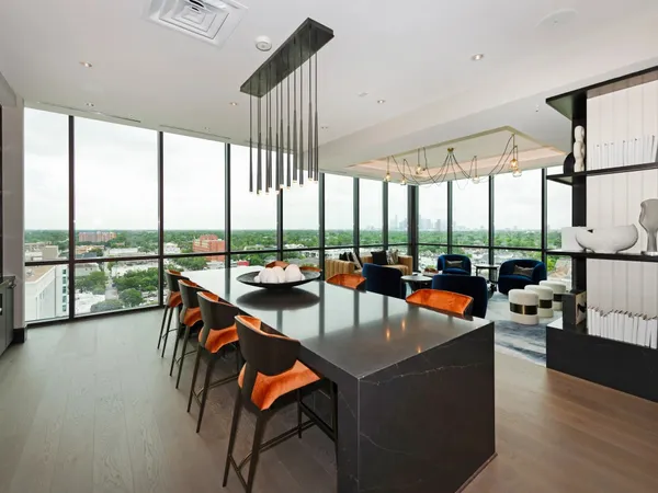 a living room with furniture and a floor to ceiling window