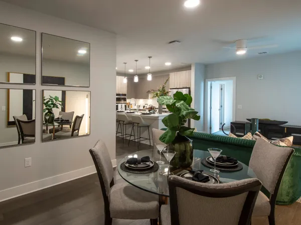 a dining room with furniture and wooden floor