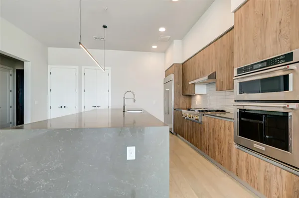 a kitchen with stainless steel appliances a stove a microwave and a refrigerator
