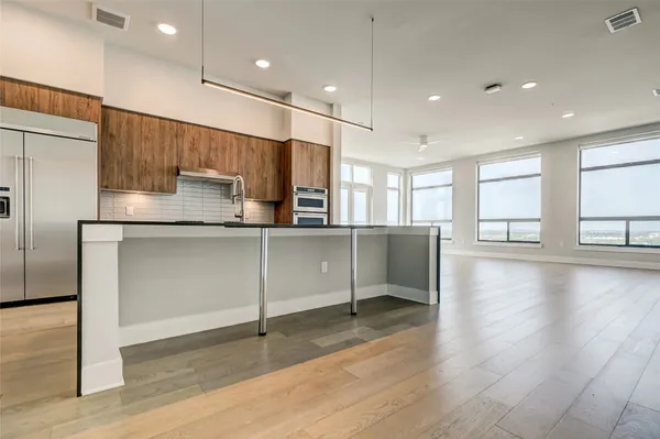 a view of a kitchen with a sink and a refrigerator