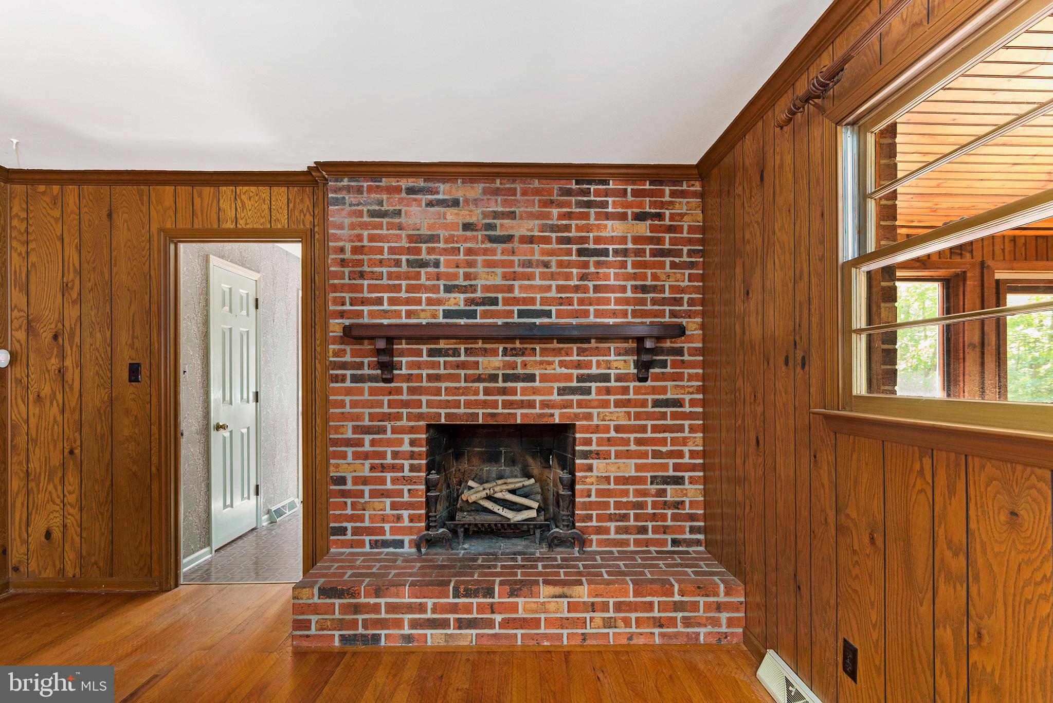 316 Caravel Drive Bear, DE 19701 - Photo 14 of 47 a view of an empty room with wooden floor and a fireplace