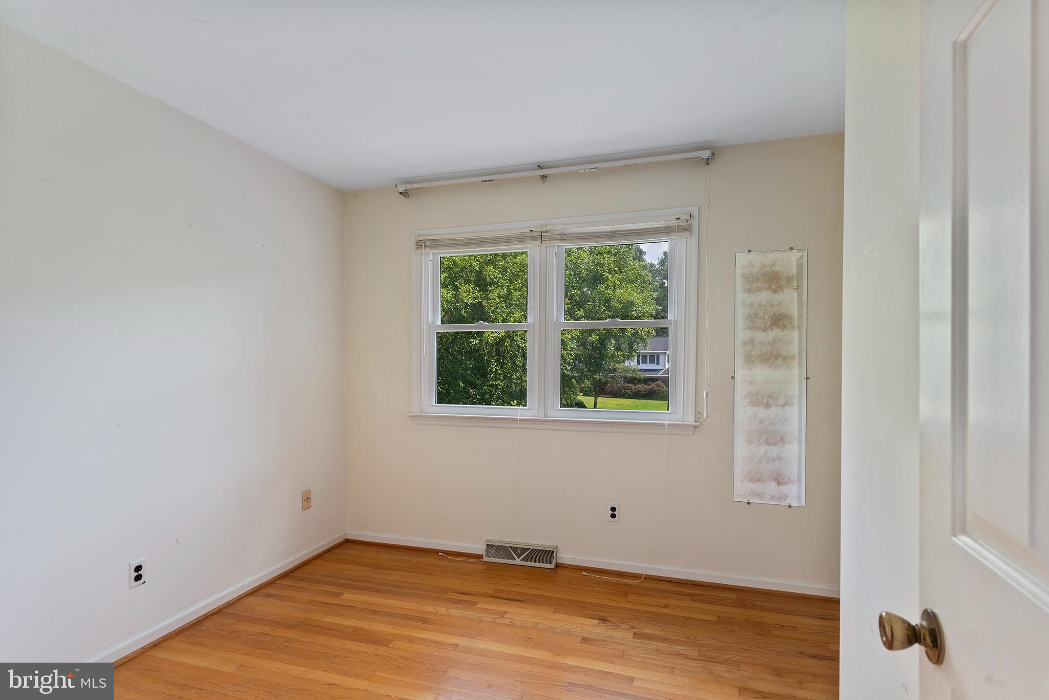 316 Caravel Drive Bear, DE 19701 - Photo 26 of 47 a view of an empty room with wooden floor and a window
