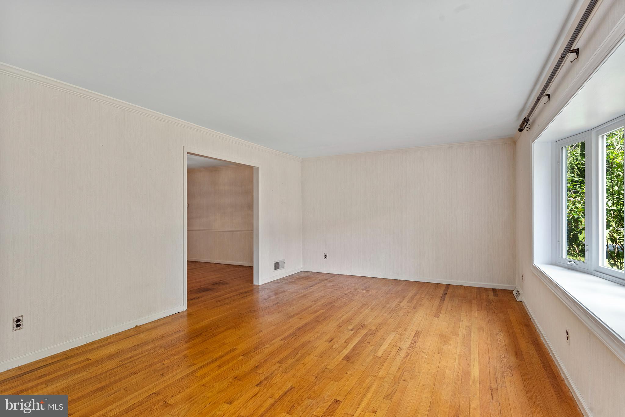 316 Caravel Drive Bear, DE 19701 - Photo 5 of 47 a view of an empty room with wooden floor and a window